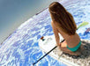 Woman on paddle board with ECOXGEAR suction cup mount on ocean, promoting Cabin Depot accessories for adventure.