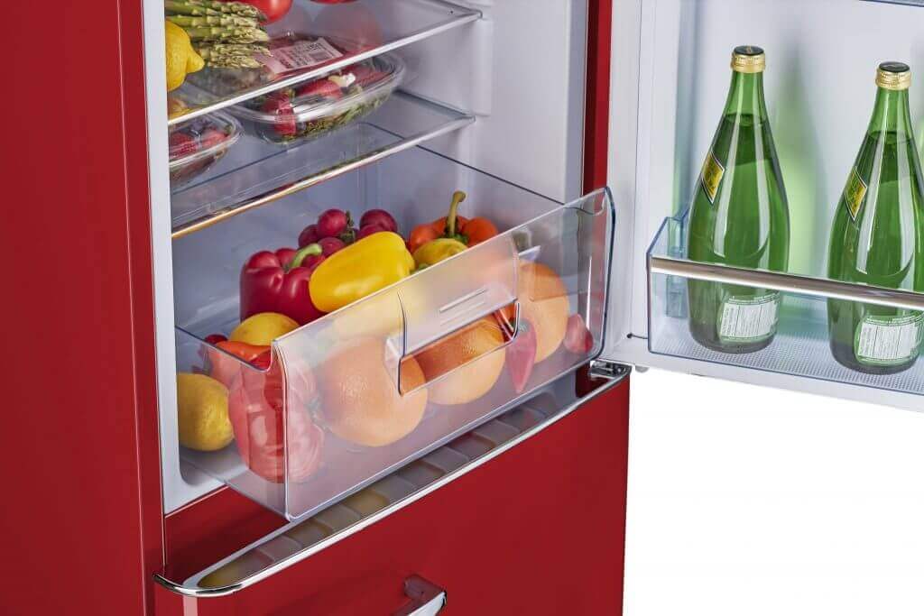 Red bottom mount retro refrigerator with open door, showing fresh fruit and drinks. Ideal for Cottage Depot and off-grid living solutions.