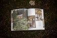 Open "Cabin Porn Inside" book showcasing cabin interiors and exteriors. Discover tranquility with Cabin Depot's inspiring guide.