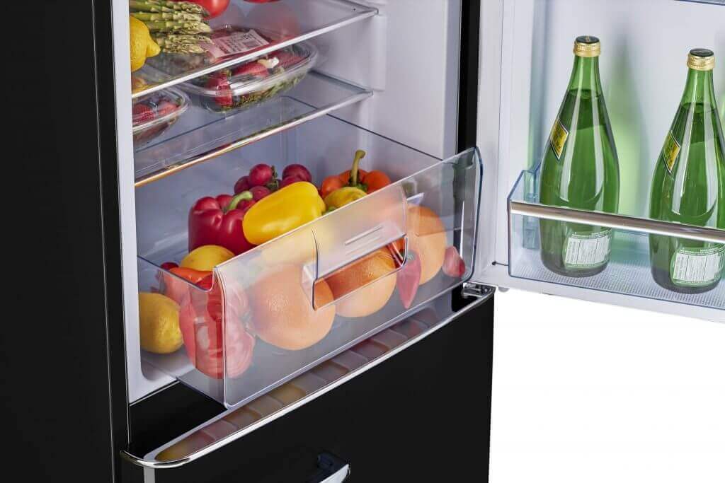 Interior of Unique 9 Cu/Ft Bottom Mount Retro Refrigerator with vegetable drawer and bottles, available at Cabin Depot.