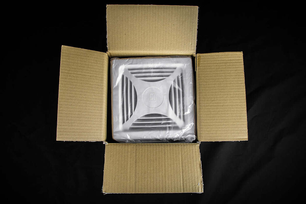 Kedron 12V DC waterproof exhaust fan in open cardboard box, ideal for bathroom ventilation in off-grid applications.