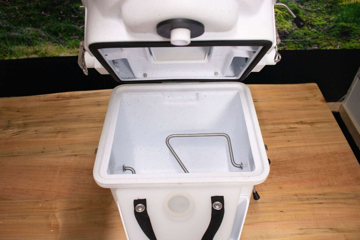 Nature's Head composting toilet with foot spider handle open, available at Cabin Depot for off-grid living solutions.