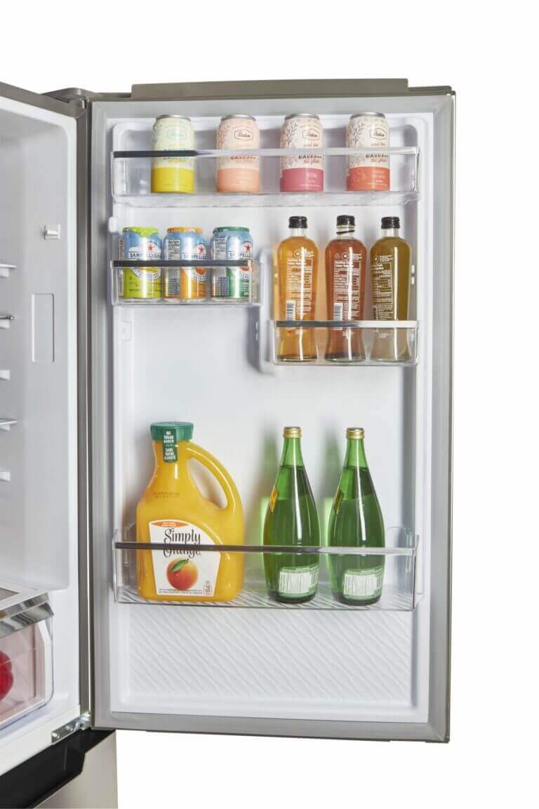 Open door view of Prestige Electric Bottom Mount Refrigerator showing organized drink storage. Available at Cabin Depot.