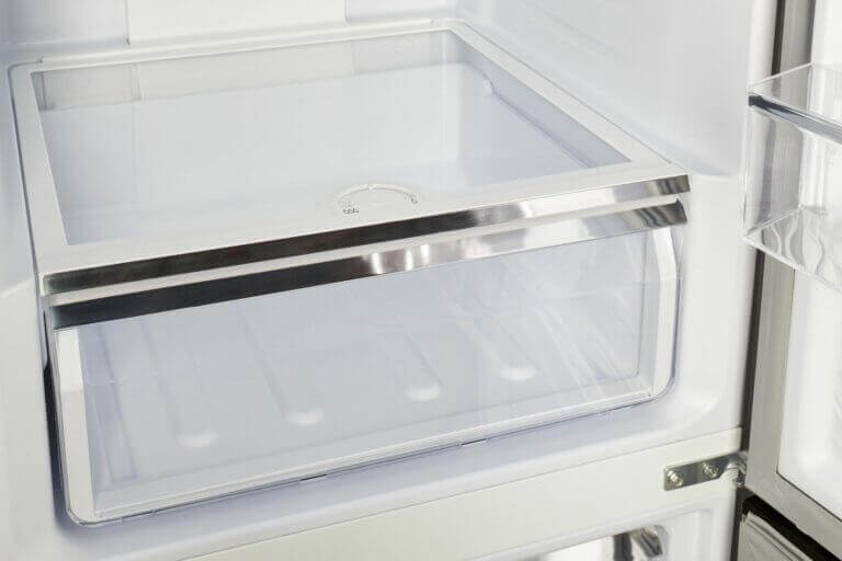 Interior view of Unique 12 Cu/Ft Prestige Electric Bottom Mount Refrigerator at Cabin Depot, showcasing sleek and spacious design.