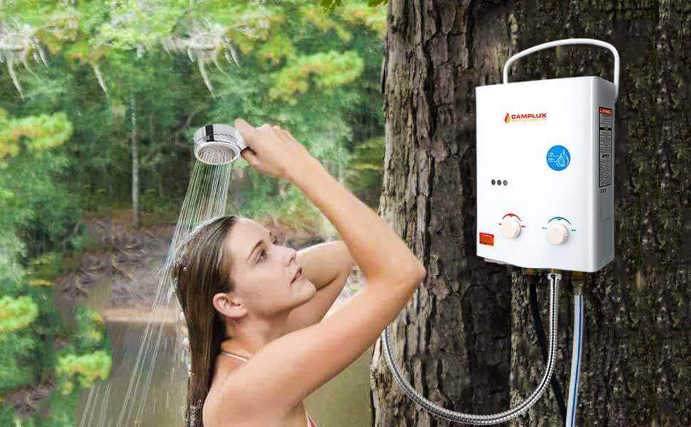 Woman using Camplux 5L Portable Tankless Water Heater outdoors, ideal for campsites and cabins, available at Cabin Depot.
