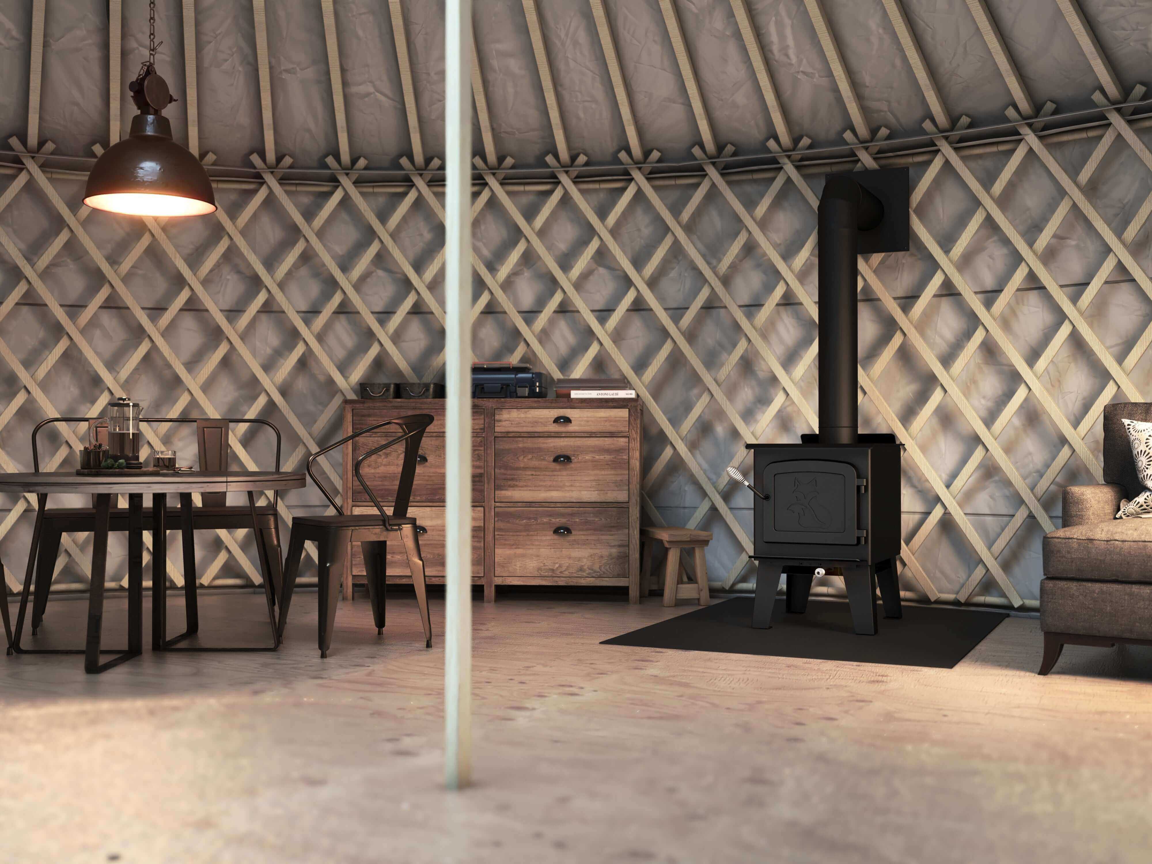 Cozy cabin interior featuring Drolet Fox Wood Stove by Cabin Depot, ideal for heating up to 1,200 ft² with 45,000 BTU/h efficiency.