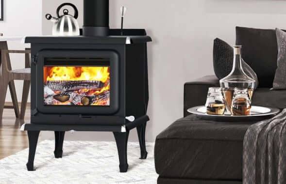 J.A. Roby Sirius Wood Stove in living room, eco-friendly heating solution from Cabin Depot with stylish design and certifications.