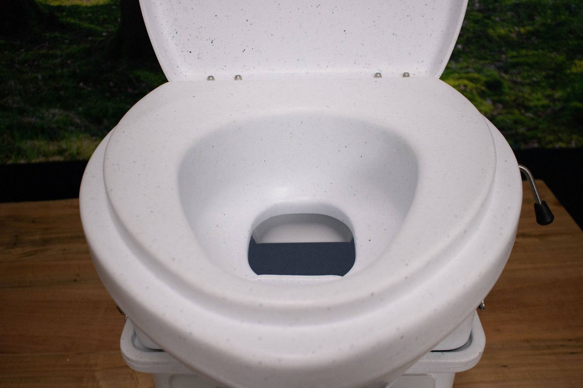 Nature's Head composting toilet with foot spider handle, available at Cabin Depot. Eco-friendly off-grid solution for remote areas.