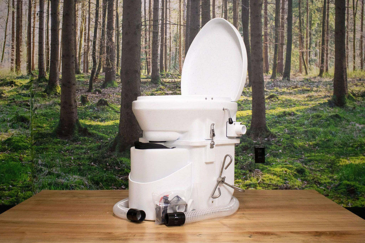Nature's Head Composting Toilet with Foot Spider Handle, available at Cabin Depot, against a forest background.