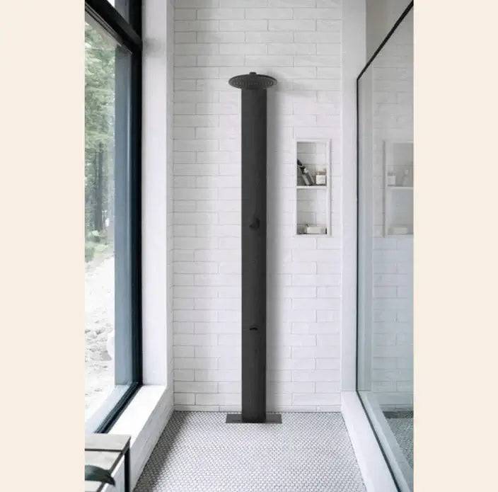 Matte black RainStick Shower in modern bathroom, doubles water flow, eco-friendly, smart home integration, available at Cabin Depot.