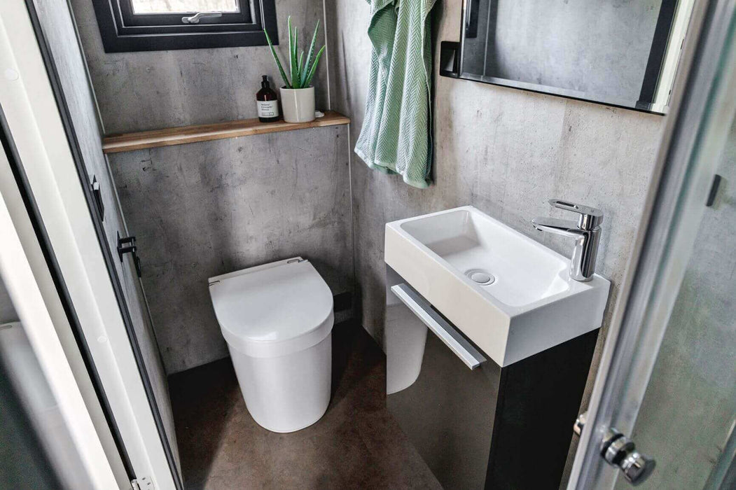 Separett Tiny 1271 Toilet in modern compact bathroom, ideal for small spaces like cabins and RVs. Available at Cabin Depot.