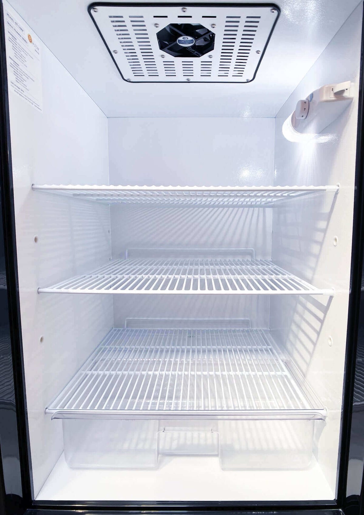 Interior shelves of SunStar 16CU Solar/DC Refrigerator from Cabin Depot, designed for off-grid use with stainless steel finish.