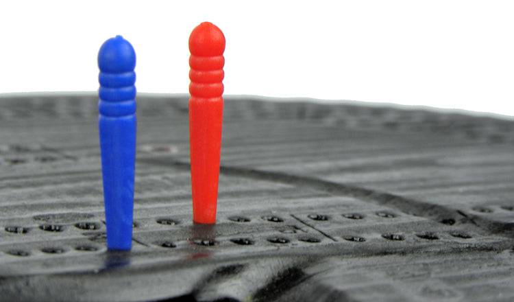 Close-up of colorful pegs on NWL Hand-Carved Bear Cribbage Board, available at Cabin Depot. Enhance your game nights with rustic charm.