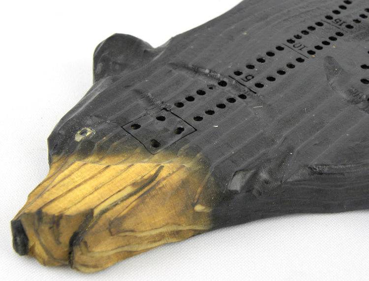 Hand-carved black bear cribbage board from Cabin Depot, showcasing holes and rustic wooden detail for cabin decor and games.