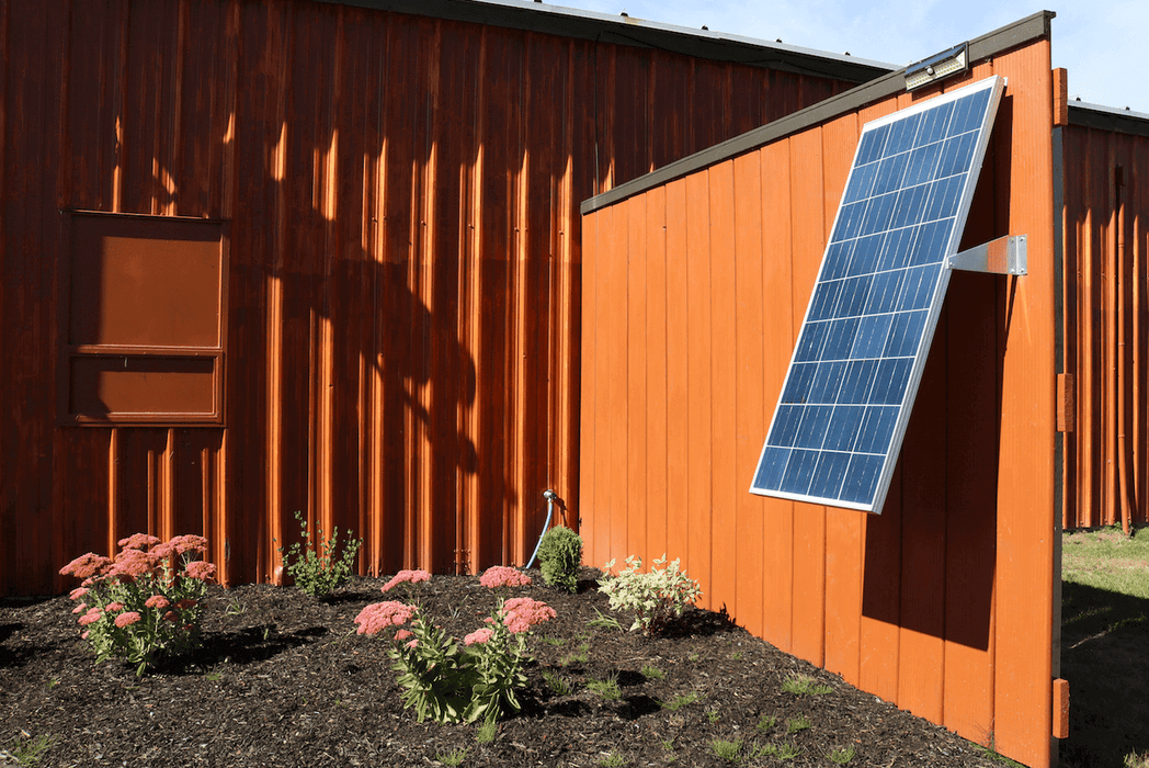 Solar panel mounted at an angle using Kedron 16" Bracket, ideal for wall installation. Available at Cabin Depot. SCREWS NOT INCLUDED.