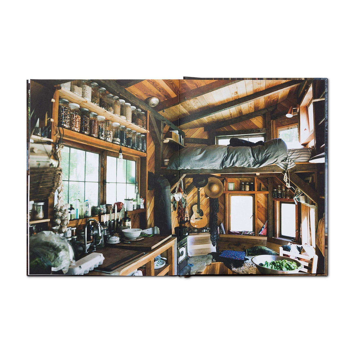 Interior of a cozy cabin from Cabin Porn Inside Book, showcasing rustic design and handmade elements from the Cabin Depot collection.