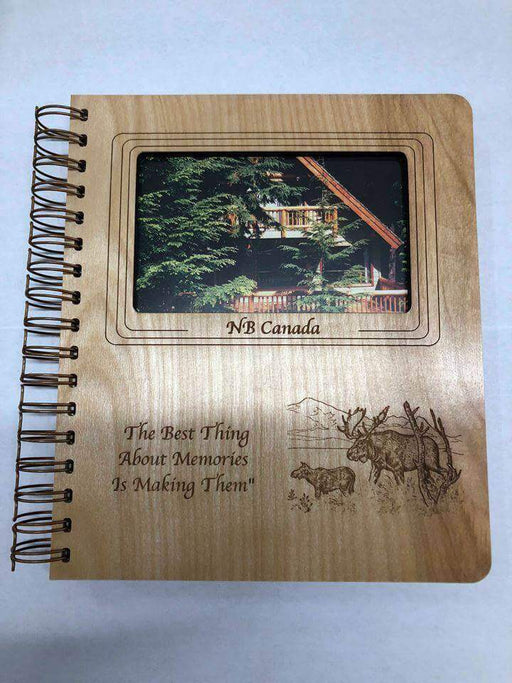 NWL Photo Album with Cabin Depot design, wooden cover featuring forest cabin image, engraved with 'The Best Thing About Memories Is Making Them'.