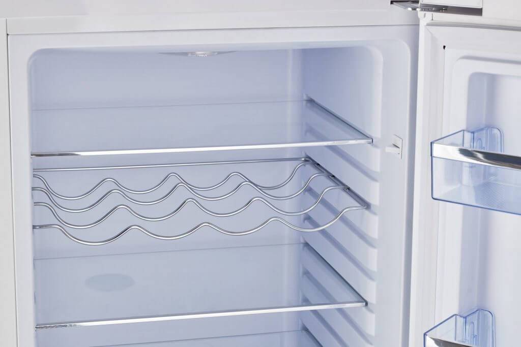 Interior view of Unique 9 cu/ft Retro Bottom Mount Fridge, showcasing spacious shelving and storage, available at Cabin Depot.