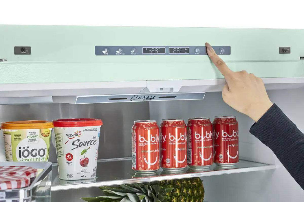 Person adjusting temperature in Unique 21.4 Cu/Ft 595L French Door Refrigerator with drinks inside, available at Cabin Depot.